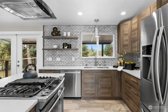 This stylish kitchen is both beautiful and functional with great use of space.  Sleek quartz counters brighten the area, add a modern flare and are easy to maintain.
