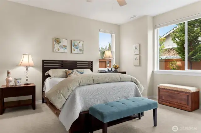 Generous primary suite looks out to back yard