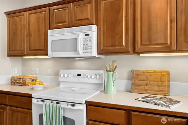 Kitchen has lots of cabinet for storage.