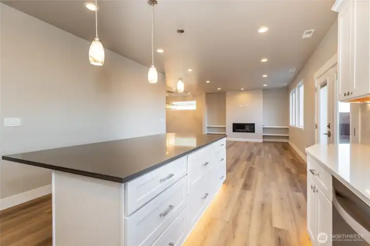 Kitchen island looking back into living room area of like home