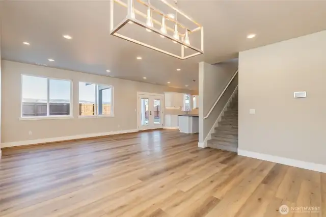 Dining room leading into living room of like home
