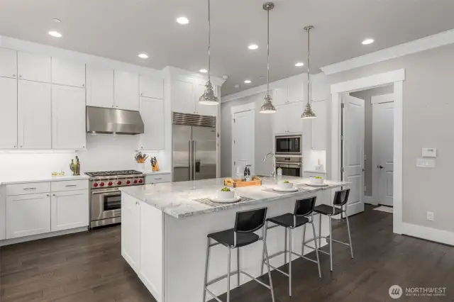 Chef's Kitchen with top of the line appliances, central kitchen and large walk-in-pantry