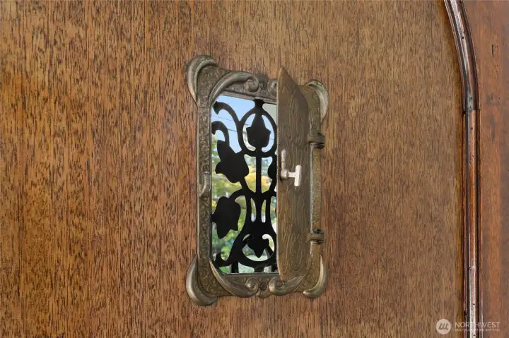 A vintage "peep-hole" inset in the front door.