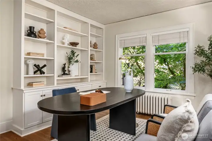 This is either a main floor den/office or a 4th bedroom (or both if you add a Murphy bed or sleeper sofa).  If using as your office there is plenty of built-in storage and bookcase space plus a closet.  Love the greenery outside the windows!