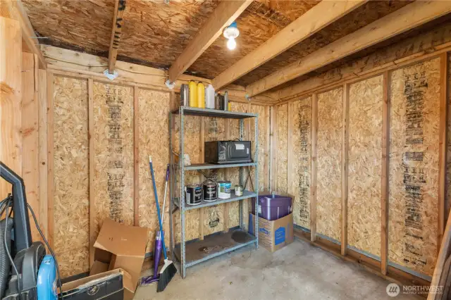 The generous sized storage shed at the end of the carport