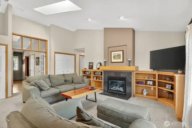Natural gas fireplace with slate surround and hearth. Built in mantle & shelves. As you can see, the vaulted ceilings flow into the room and skylights add to lots of natural light!