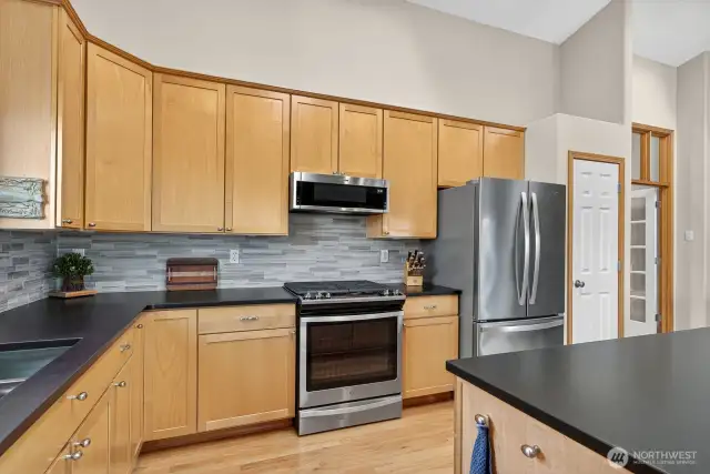 A close up of the kitchen counters & tile backsplash.