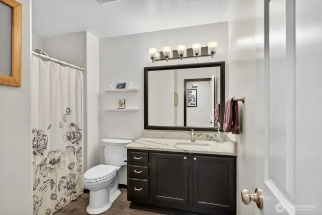 Full guest bath with granite counter top, & LVT flooring.