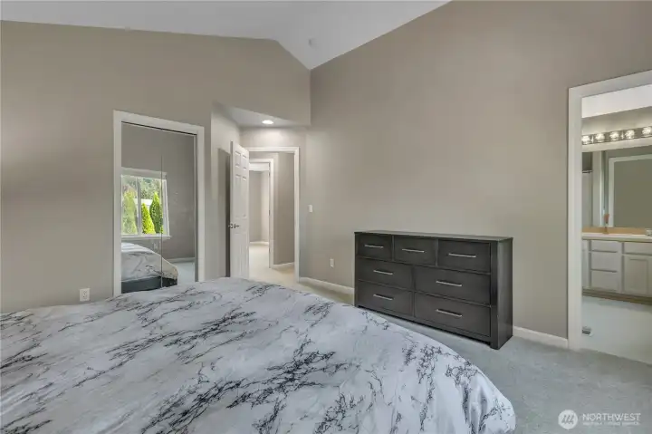 Another view of the large, primary suite. The access to the private bathroom is just to the right. The walk-in closet is just behind the mirrored doors to the left.