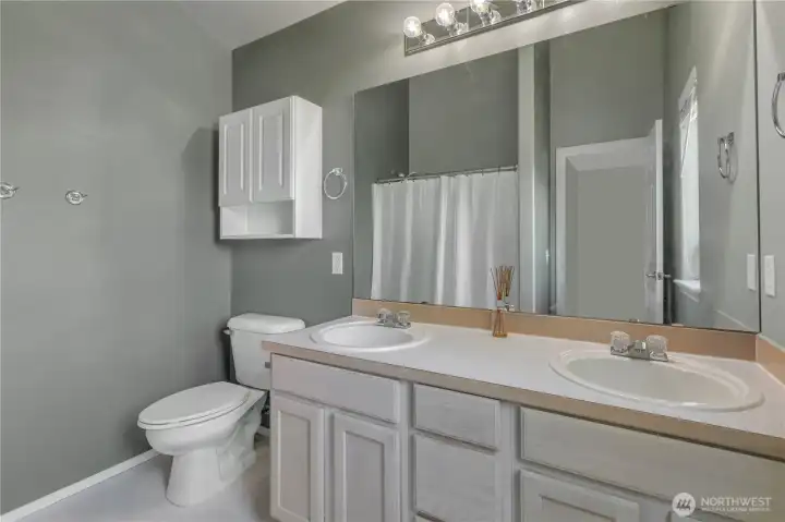 The primary bathroom has double sinks and a relaxing bathtub too.