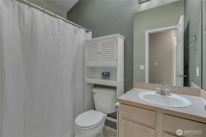 The upper full main bathroom has vaulted ceilings and a bright skylight and adds so much natural light!