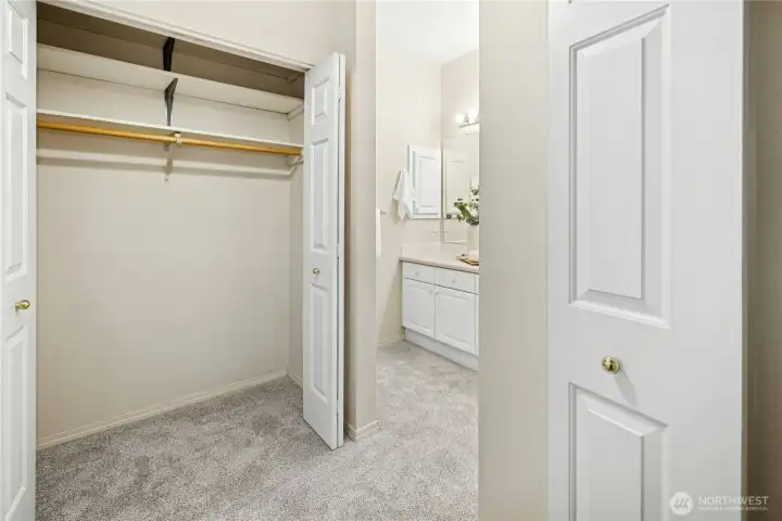 Ample closet space between the primary bedroom and bath.