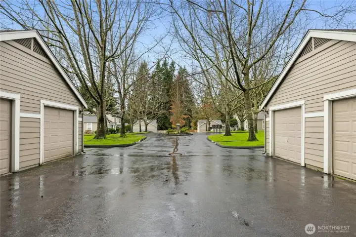 The detached one-car garage is on the right. The extra dedicated parking space is the first space to the right of the garage.