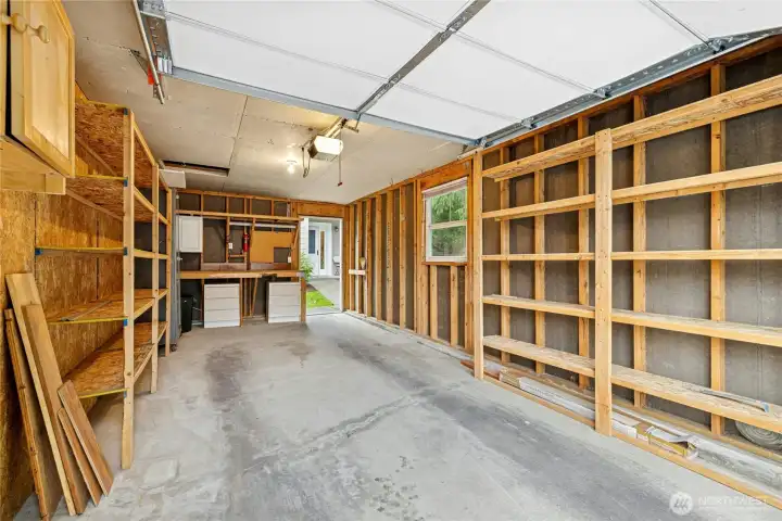 The garage is lined with storage shelving.