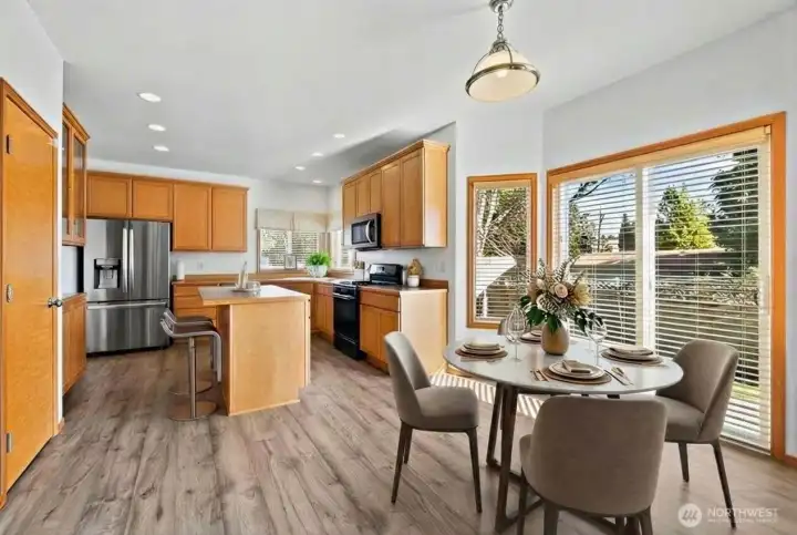 The eating area with sliding glass doors leads out to the back patio and fully fenced backyard. (photo vitrually staged)