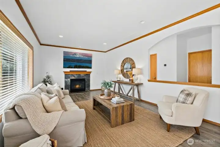 Cozy up in front the gas fireplace in the living room. (photo virtually staged)