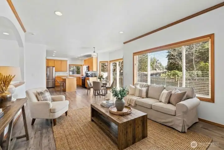 Open concept living room, eating area and kitchen. (photo virtually staged)