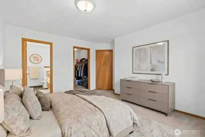 Primary bedrom features walk-in closet and full bathroom. (photo virtually staged)