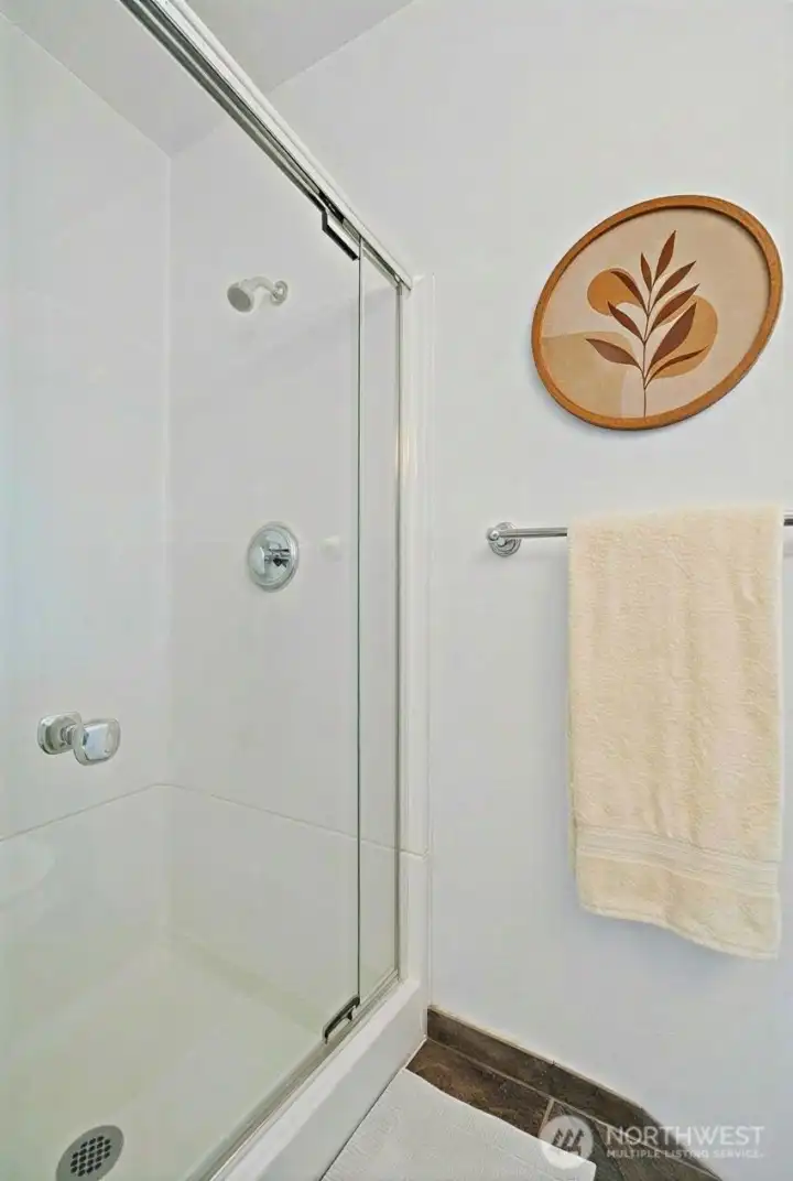 Primary bathroom shower. (photo virtually staged)