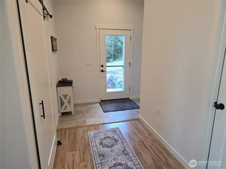 Welcoming entry way with coat closet.