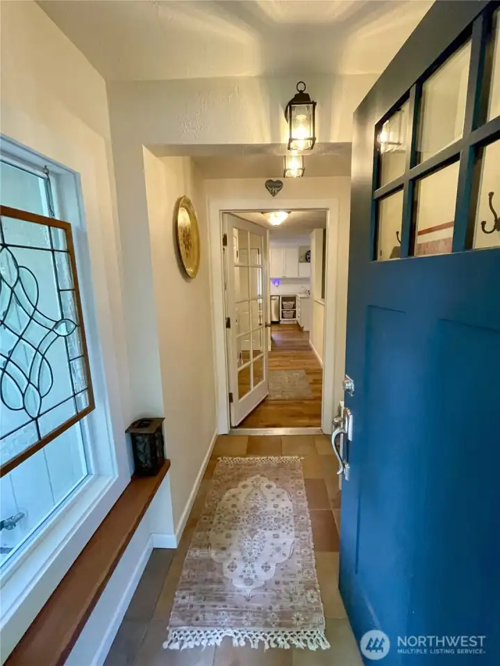 Tiled entryway to drop coats and shoes
