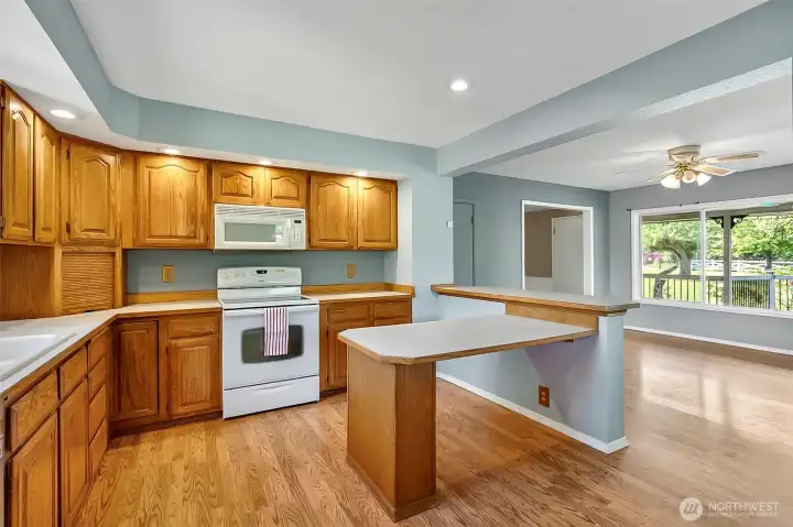 Kitchen with built in table, formal dining to the right.