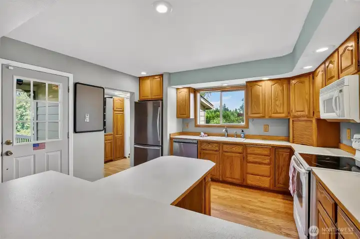 Front door on the left and open entry into the walk-in panty / laundry room