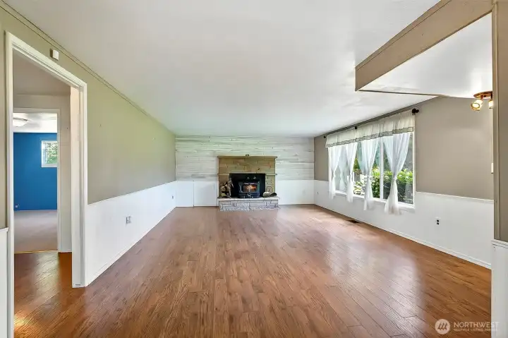 Living room with Fireplace insert, perfect for heating and can be used for cooking during power outages.  Wood box to the left of the fireplace.  Load it from outside the house and access the wood from inside!  No going out to get wood on cold winter nights!