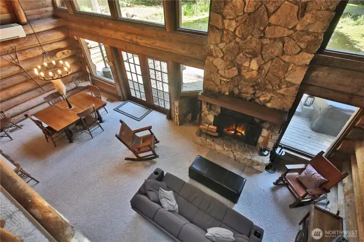 The cathedral ceilings emphasize the gorgeous logs and the tall fireplace!