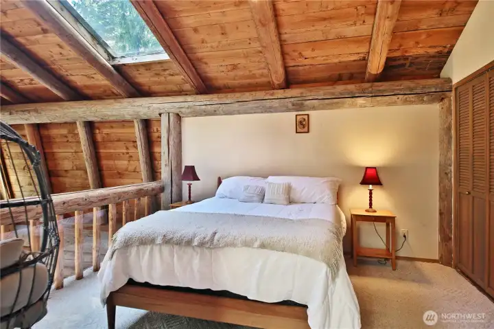 The upstairs bedroom oversees the living area.