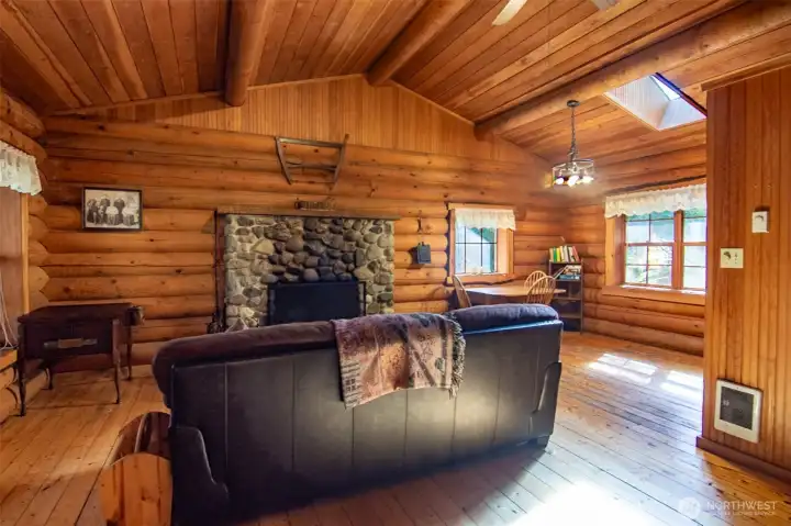 Another amazing cabin with a wood fireplace for a cozy living and dining room.