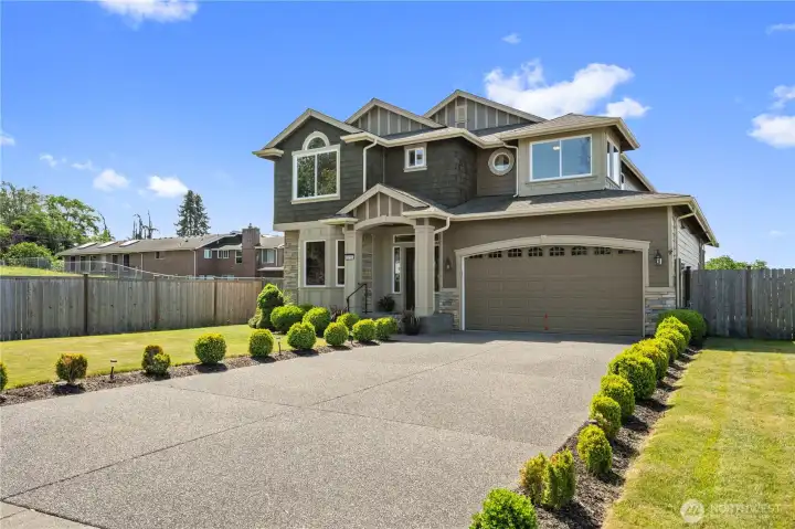 Step inside to soaring ceilings, rich hardwood floors, and an impressive iron staircase that sets the tone for the home's custom design.