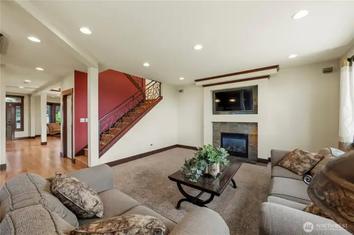 The inviting family room centers around a beautiful slate fireplace, creating a cozy place to relax.