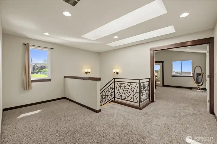 The upstairs loft offers flexible space for a home office, media room, reading nook, or play area.