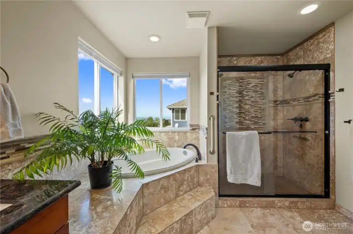 A spacious custom-tiled shower adds both elegance and functionality.