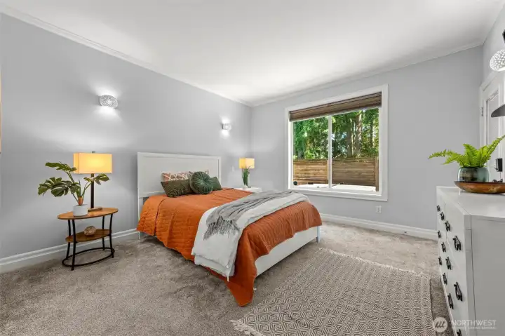 spacious primary with door that leads to back deck