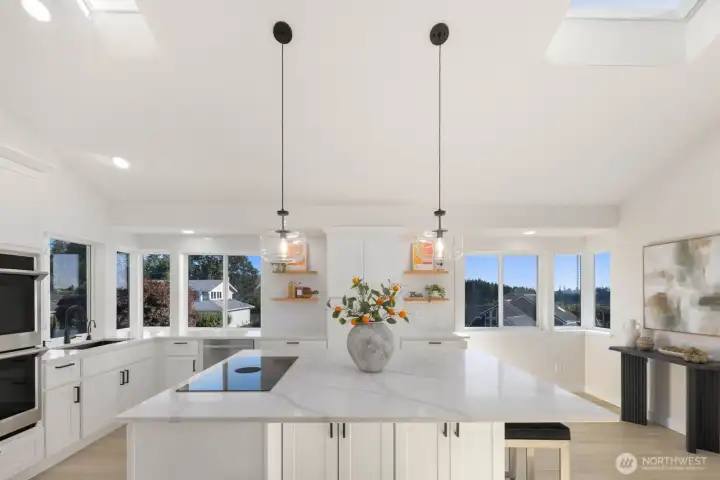Open kitchen with double ovens and stovetop.