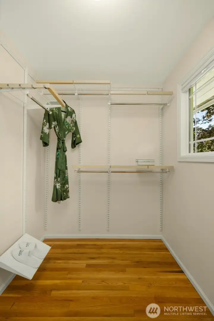 Primary walk-in closet. Shelves on the left. Primary walk-in closet. Shelves on the left.