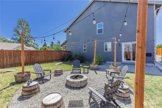 North backyard set up with seating, firepit & party lights