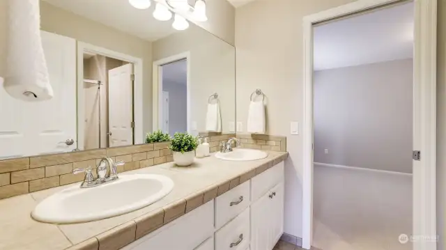 Jack and Jill full bath with #3 of the secondary bedrooms through the doorway.