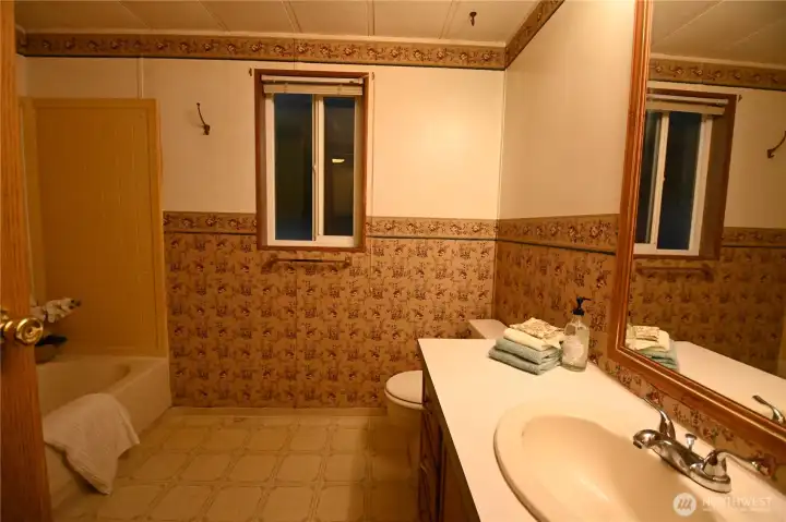 Full bath offers a functional design and floor to ceiling storage (behind the door) ~ everything you need for easy living.