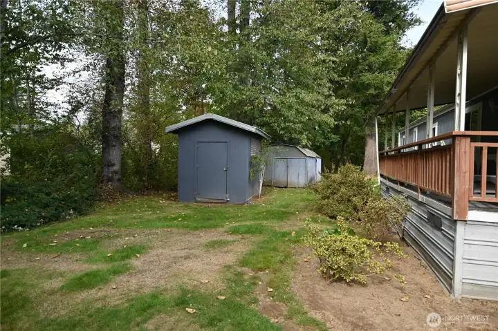 Workshop with benches and a large storage shed. Back yard abuts seasonal overflow from Wallace River.