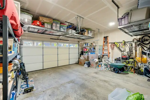 Two car garage with overhead storage racks for all the holiday, camping or off season garments.