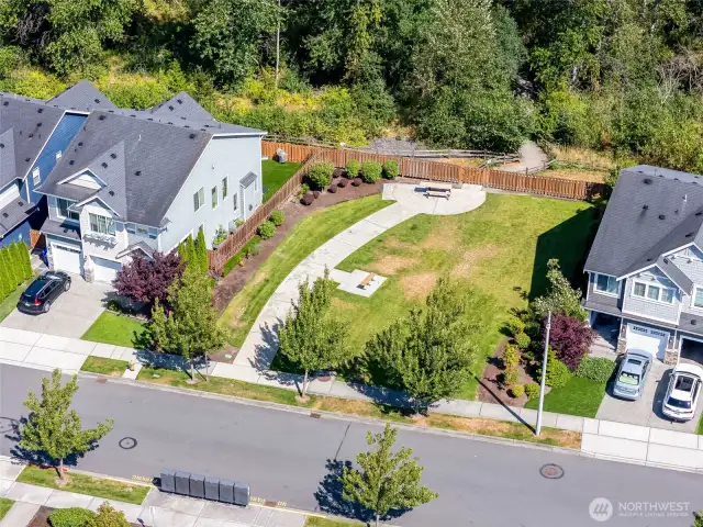 Another community shared space with trail visible past the fenceline.