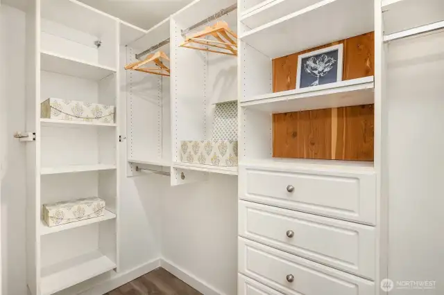 Primary walk-in closet offers extra drawers and shelves to keep you organized.
