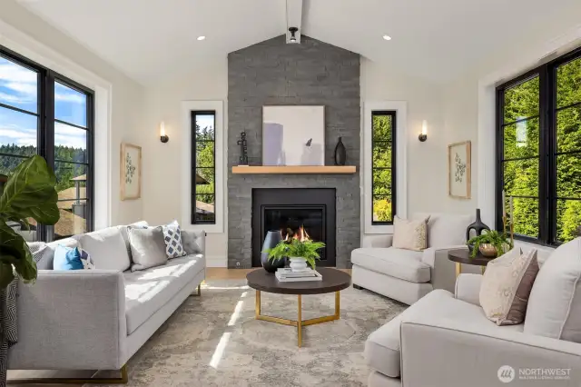 Livingroom featuring generous windows with stacked stone fireplace and custom mantel