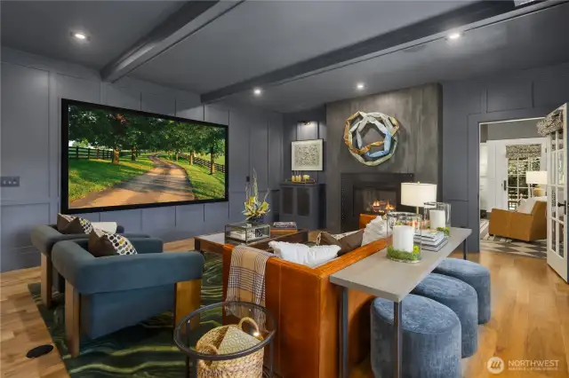 State of the art media room features a rojected screen TV with custom speakers built in behind the screen