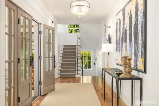 Heading upstairs, the stairwell has custom railings with powder coated spindles and walnut handrail