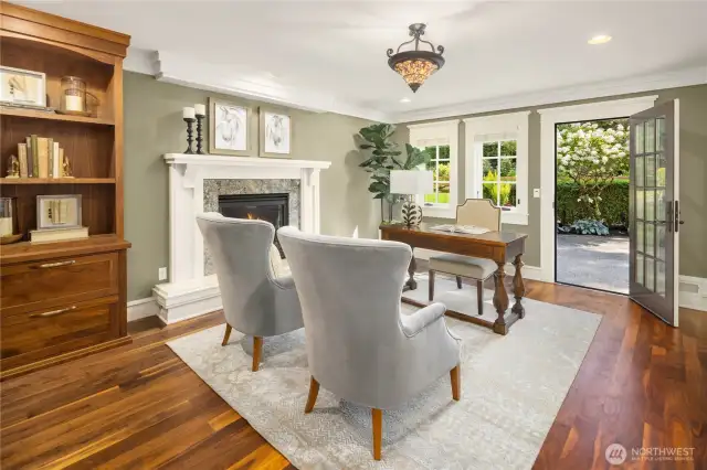 Garden level office with built-in bookcases and fireplace