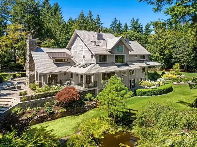 Gorgeous exterior details including cultured stone and cedar siding, clear cedar soffits, oversized painted exterior trim, wood windows with divided lights and a metal clad exterior